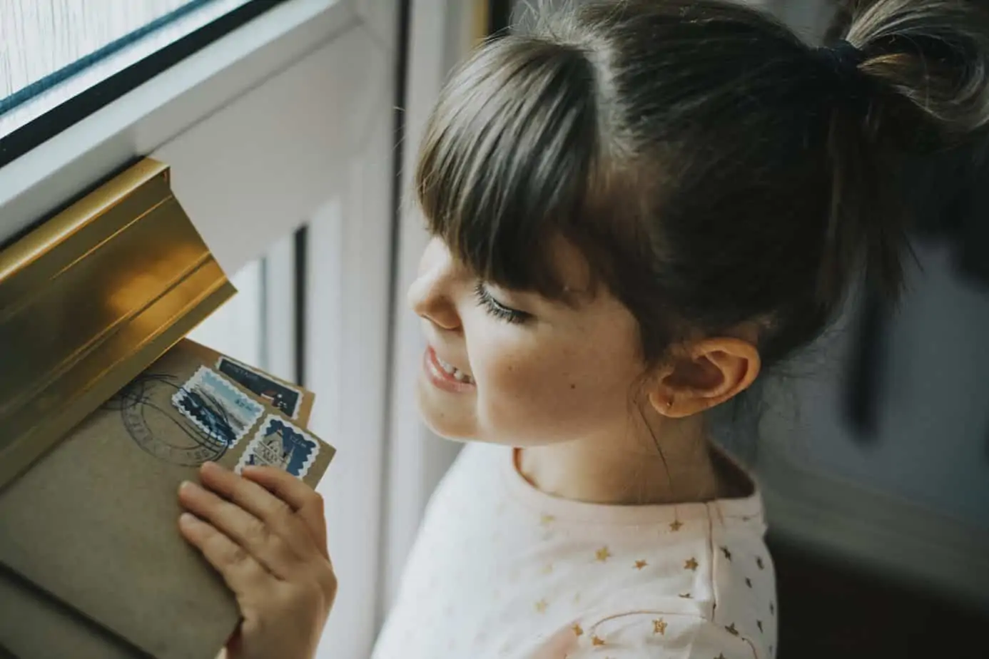 A child excitedly checking the mailbox for birthday cards.