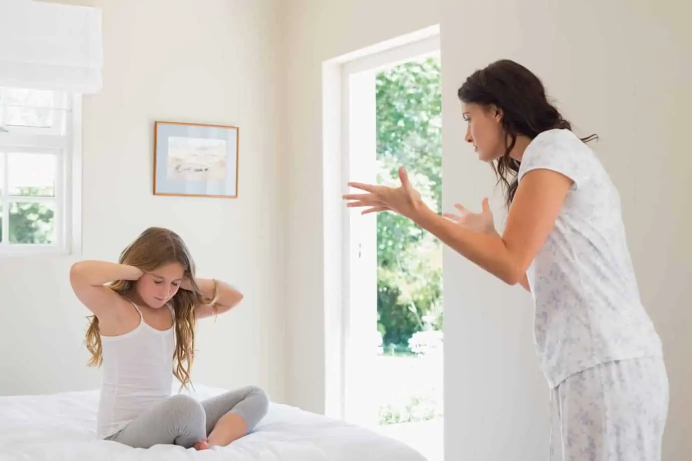 Tired mom sitting at home, learning calming techniques instead of yelling