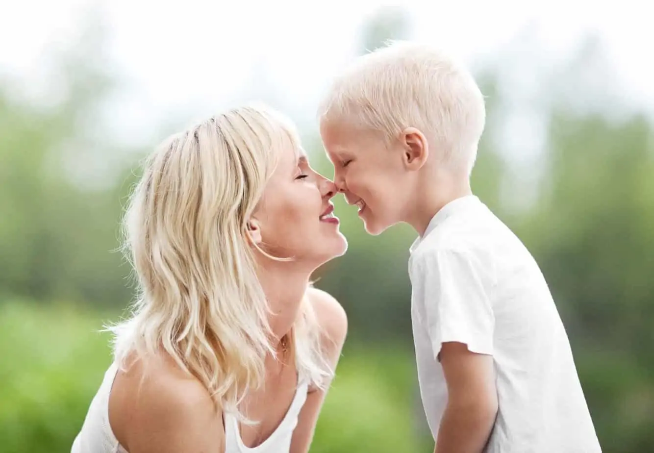 Mom kneeling to her child's level and using eye contact to help him listen