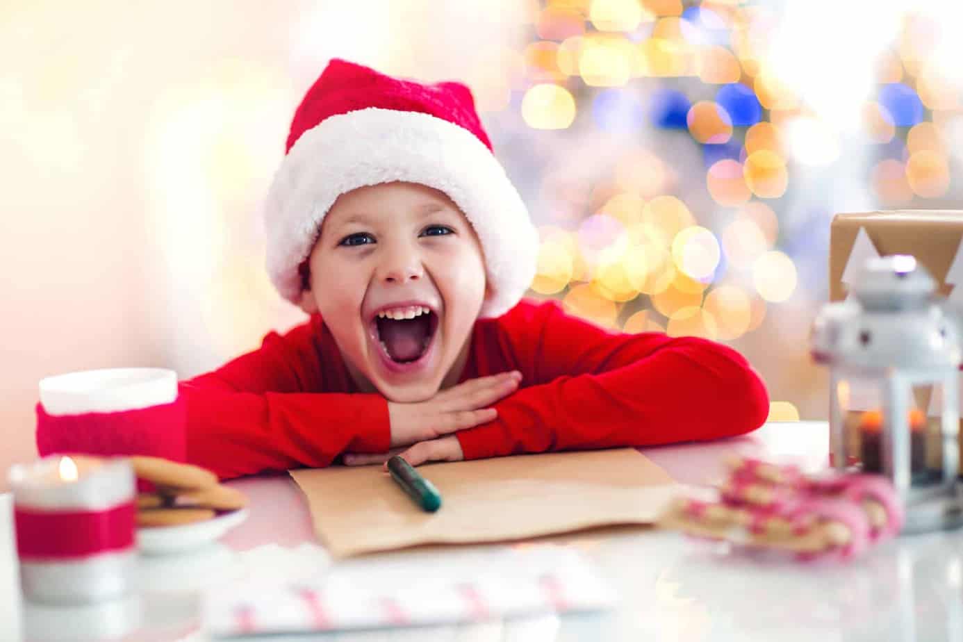 boy writing a letter to santa with free printable template.jpg