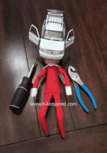 elf on the shelf working on the car