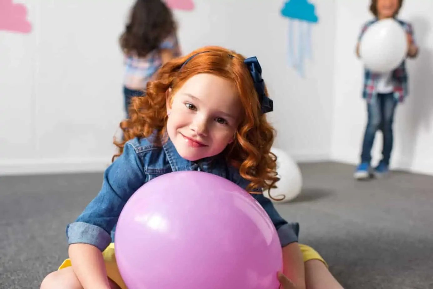 A happy little girl at a birthday party — 50 goodie bag alternatives that aren't plastic junk or candy.