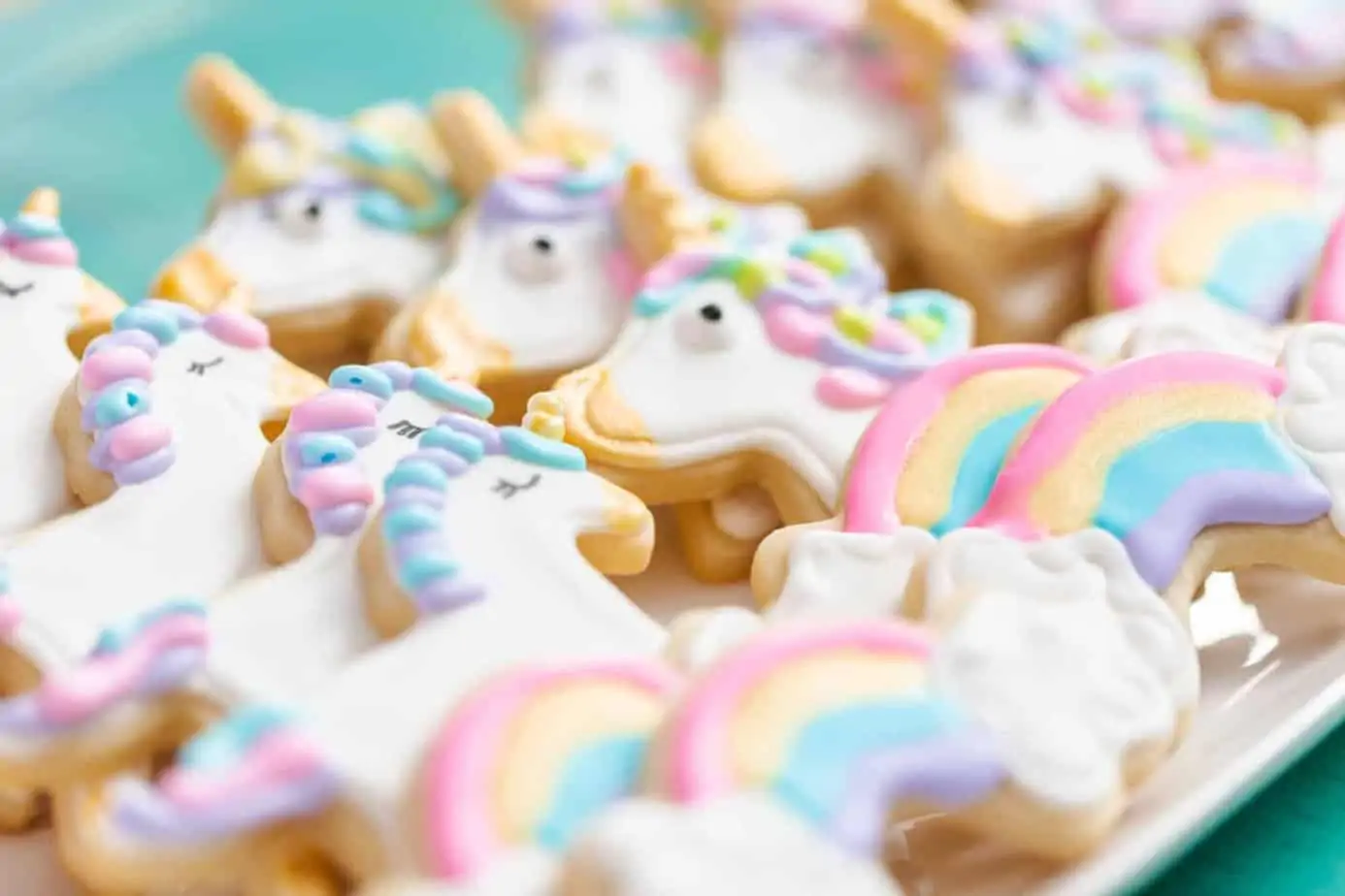 Decorated unicorn cookies as a take-home treat alternative to a goody bag.